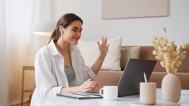 A woman greets her online accent coach.