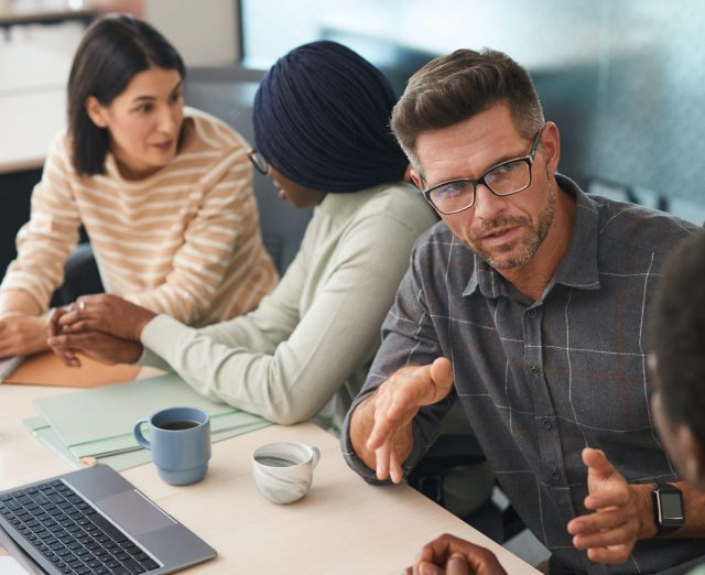 Workmates chat over their projects