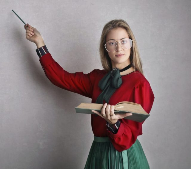 A teacher points to the board