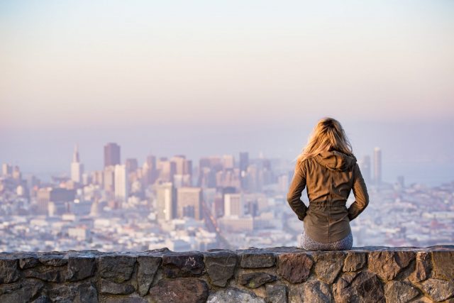 A woman looks out over the cityscape
