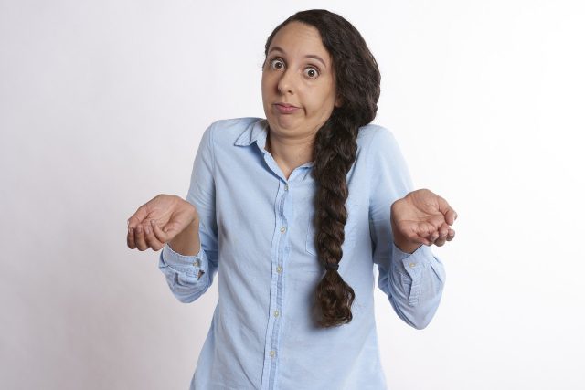 A woman shows her confusion with her facial expression
