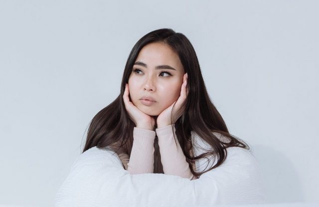 Young Asian woman contemplates her challenges
