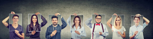 People hold portraits over their faces