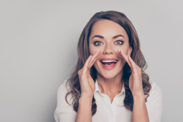 A woman speaks up with clear articulation.