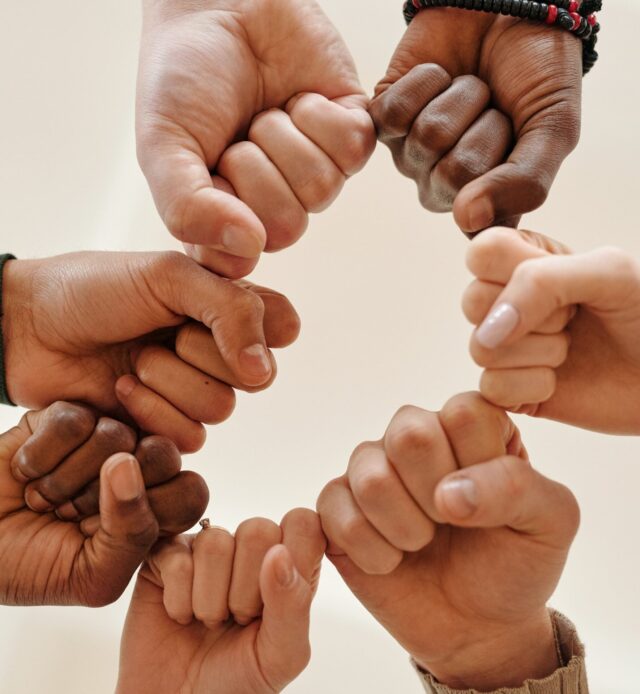 Several hands come together in team spirit