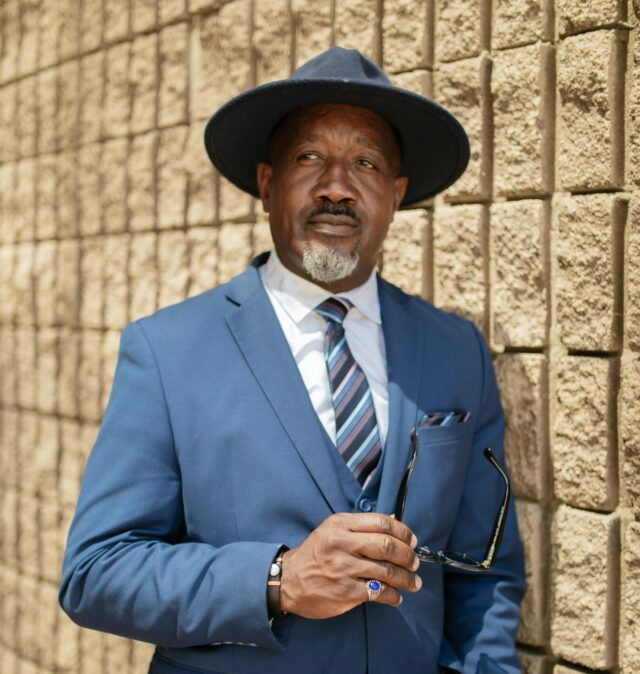 An American man stands thoughtfully