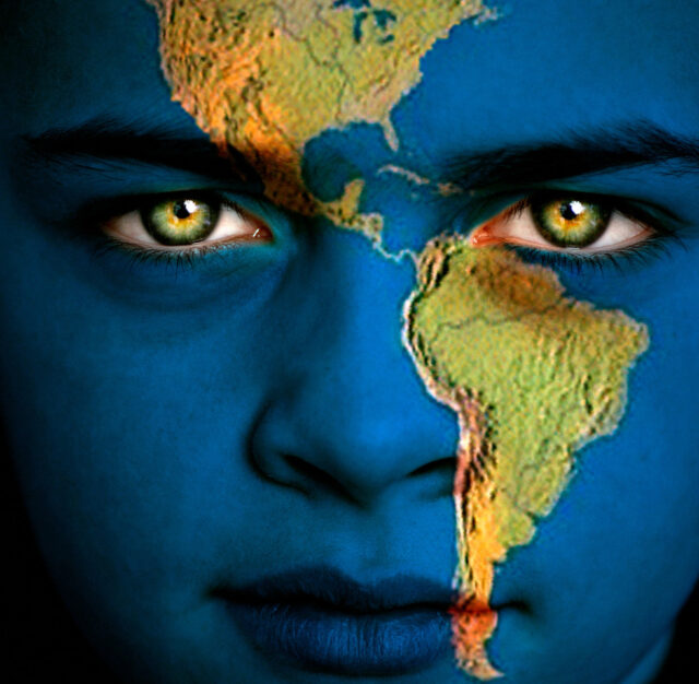 The shadow of a woman's face appears over North and South America.