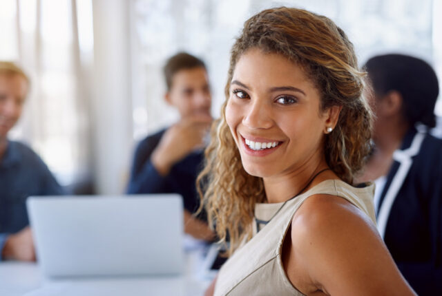 A young woman rejoices at her success in a meeting