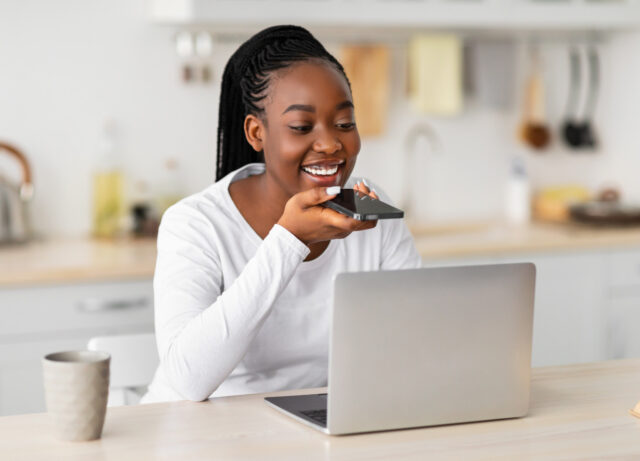 Woman uses a recording app on her phone to check her pronunciation.