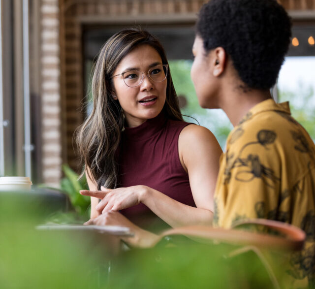 Two women converse comfortably
