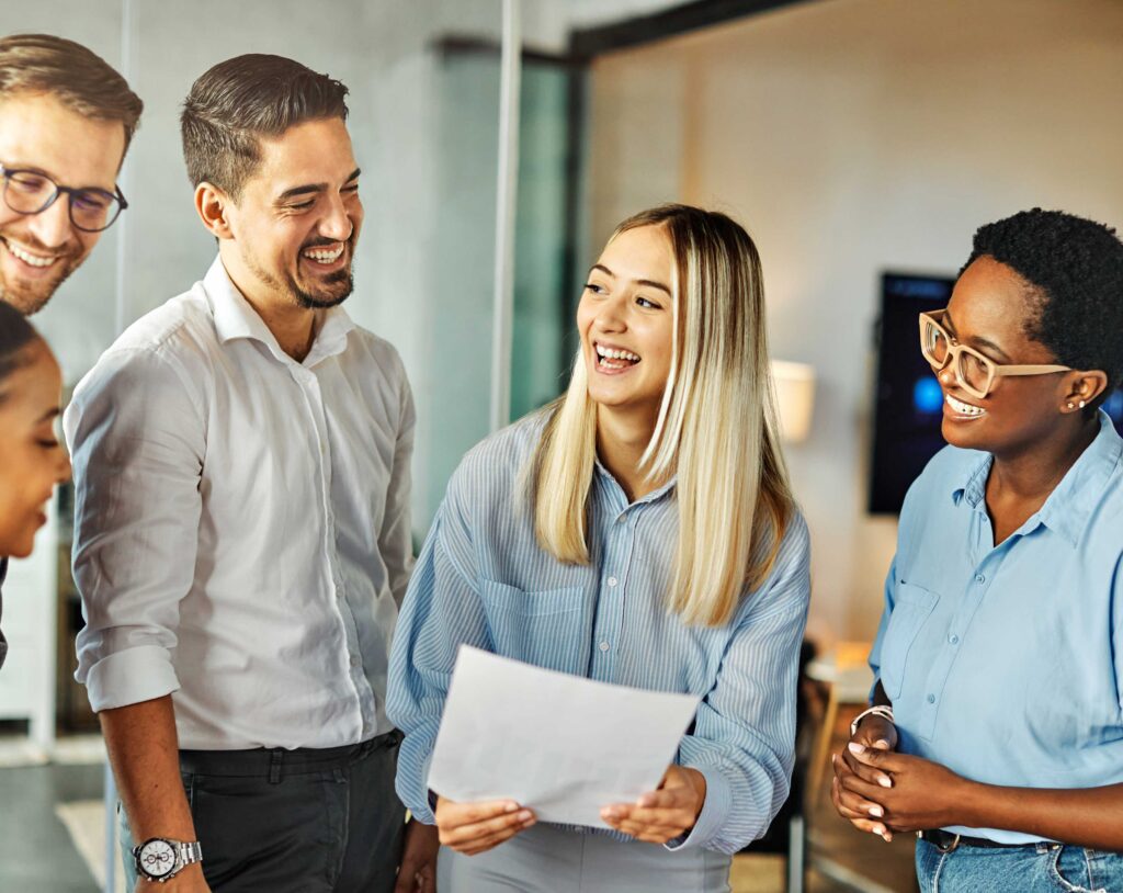 A group of people laughing in a business setting